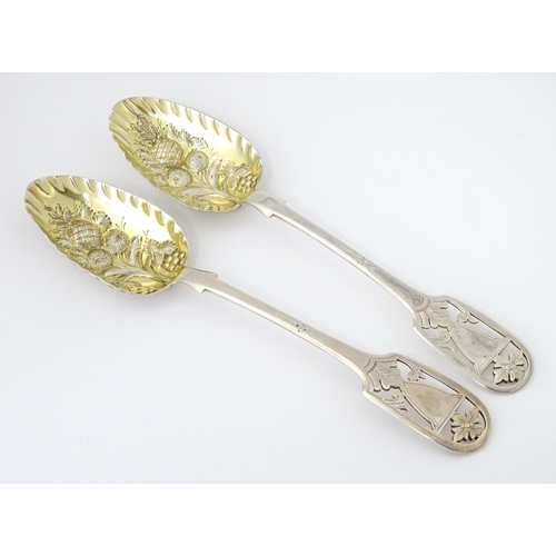 325 - A pair of William IV silver berry spoons with openwork detail to handles and gilded bowls, hallmarke... 