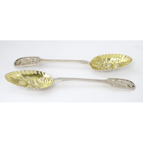 325 - A pair of William IV silver berry spoons with openwork detail to handles and gilded bowls, hallmarke... 