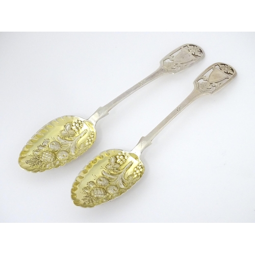 325 - A pair of William IV silver berry spoons with openwork detail to handles and gilded bowls, hallmarke... 