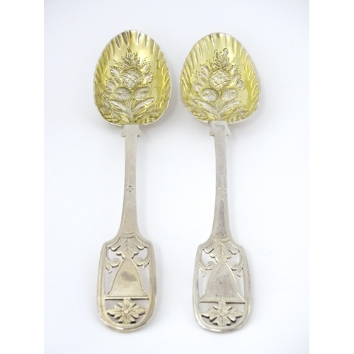 325 - A pair of William IV silver berry spoons with openwork detail to handles and gilded bowls, hallmarke... 