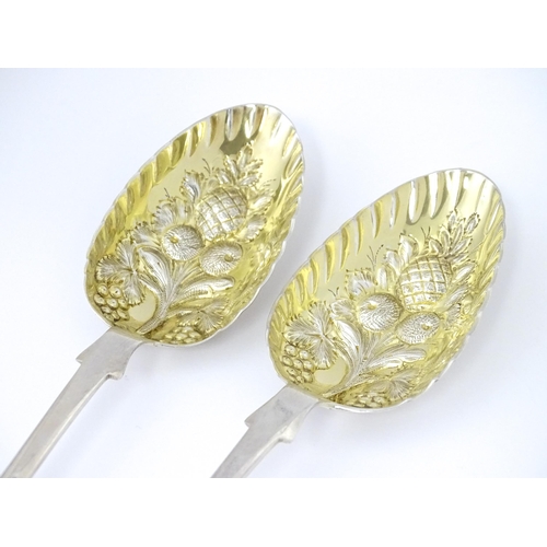 325 - A pair of William IV silver berry spoons with openwork detail to handles and gilded bowls, hallmarke... 