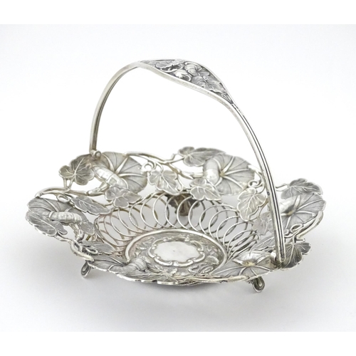 328 - A Victorian silver bon bon dish with floral and foliate decoration and swing handle, hallmarked Birm... 