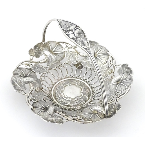 328 - A Victorian silver bon bon dish with floral and foliate decoration and swing handle, hallmarked Birm... 