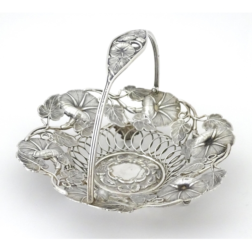 328 - A Victorian silver bon bon dish with floral and foliate decoration and swing handle, hallmarked Birm... 