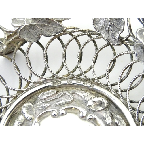 328 - A Victorian silver bon bon dish with floral and foliate decoration and swing handle, hallmarked Birm... 