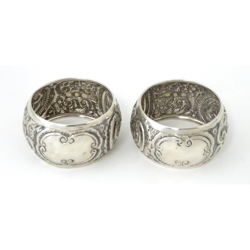 331 - A pair of Victorian silver napkin rings with embossed decoration, hallmarked Birmingham 1892, maker ... 