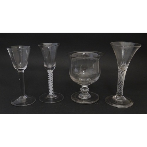 254 - Four assorted 18thC and later drinking glasses to include examples with air twist stems. Largest app... 