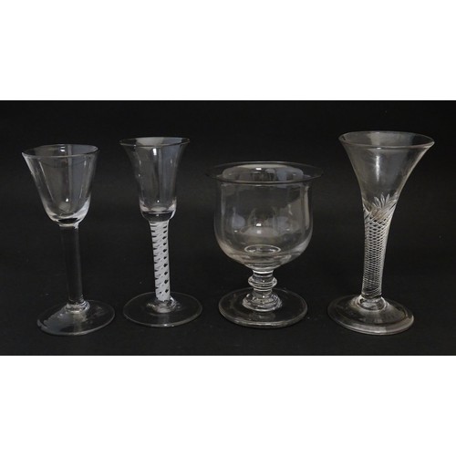 254 - Four assorted 18thC and later drinking glasses to include examples with air twist stems. Largest app... 