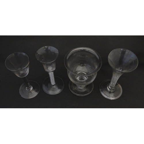 254 - Four assorted 18thC and later drinking glasses to include examples with air twist stems. Largest app... 