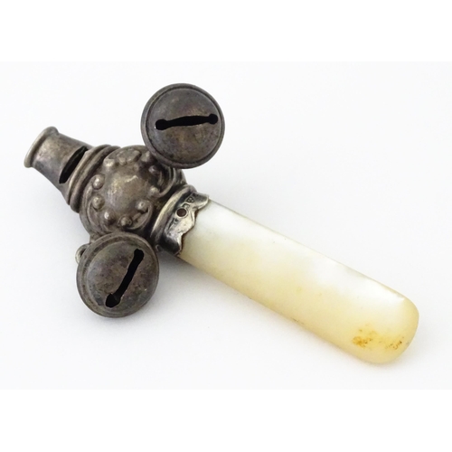 335 - A silver child's rattle with mother of pearl teether handle and whistle to one end, hallmarked Chest... 