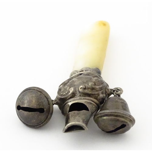 335 - A silver child's rattle with mother of pearl teether handle and whistle to one end, hallmarked Chest... 