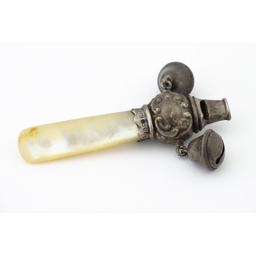 335 - A silver child's rattle with mother of pearl teether handle and whistle to one end, hallmarked Chest... 