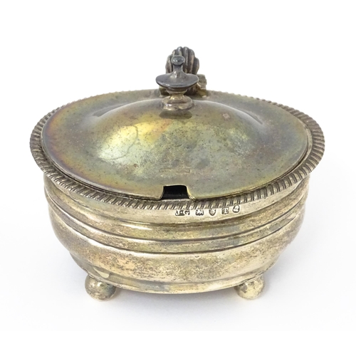 348 - A George III silver mustard pot with blue glass liner hallmarked London 1814, maker Jeremiah Garfiel... 