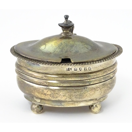 348 - A George III silver mustard pot with blue glass liner hallmarked London 1814, maker Jeremiah Garfiel... 