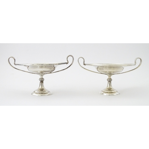 349 - A pair of silver twin handled pedestal bon bon dishes of tazza form, hallmarked London 1904, maker H... 