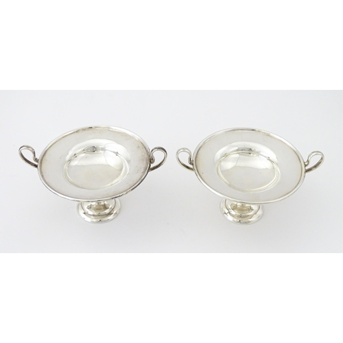 349 - A pair of silver twin handled pedestal bon bon dishes of tazza form, hallmarked London 1904, maker H... 