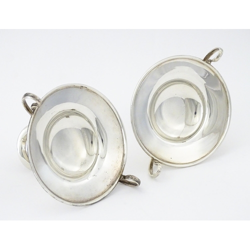 349 - A pair of silver twin handled pedestal bon bon dishes of tazza form, hallmarked London 1904, maker H... 