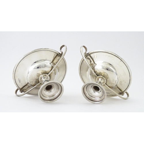 349 - A pair of silver twin handled pedestal bon bon dishes of tazza form, hallmarked London 1904, maker H... 