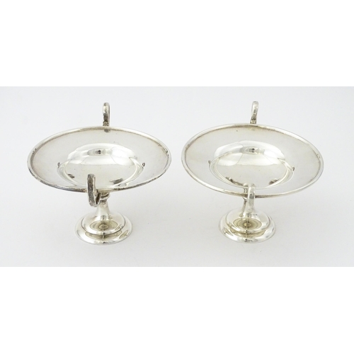 349 - A pair of silver twin handled pedestal bon bon dishes of tazza form, hallmarked London 1904, maker H... 