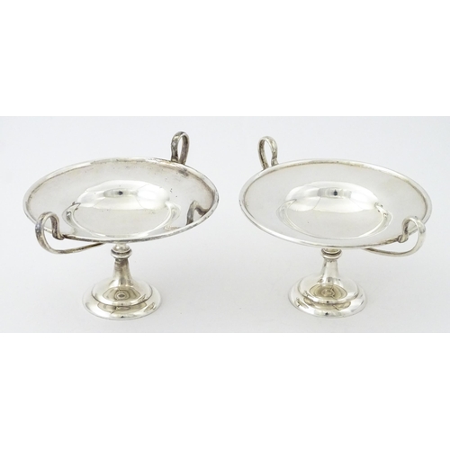 349 - A pair of silver twin handled pedestal bon bon dishes of tazza form, hallmarked London 1904, maker H... 