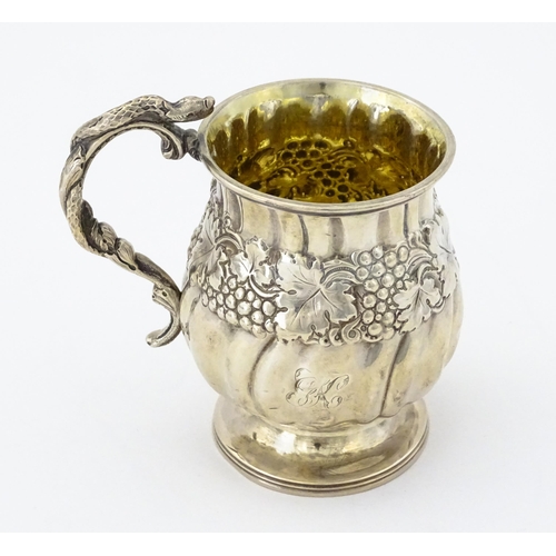 353 - A George III silver christening mug with embossed fruiting vine decoration, serpent formed handle an... 