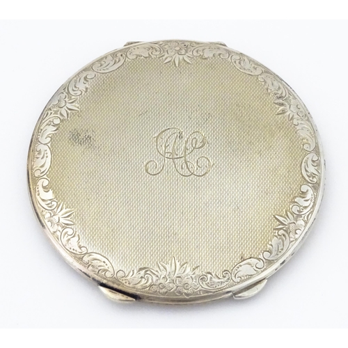 357 - A Continental .830 silver powder compact with engine turned decoration and engraved decoration, mark... 