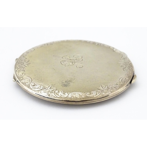 357 - A Continental .830 silver powder compact with engine turned decoration and engraved decoration, mark... 