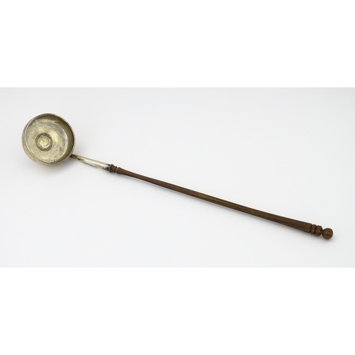 360 - A white metal toddy ladle with turned wooden handle, with inset 1816 coin style detail to centre. Ap... 