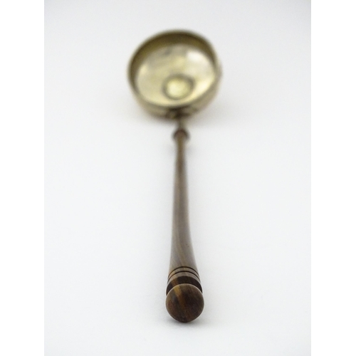 360 - A white metal toddy ladle with turned wooden handle, with inset 1816 coin style detail to centre. Ap... 