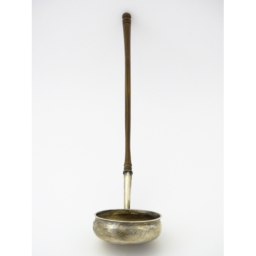 360 - A white metal toddy ladle with turned wooden handle, with inset 1816 coin style detail to centre. Ap... 