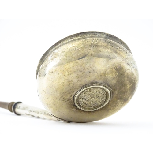 360 - A white metal toddy ladle with turned wooden handle, with inset 1816 coin style detail to centre. Ap... 