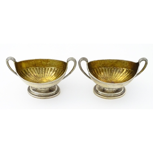 361 - A pair of George III silver twin handled salts with gilded interiors, hallmarked London 1784, maker ... 