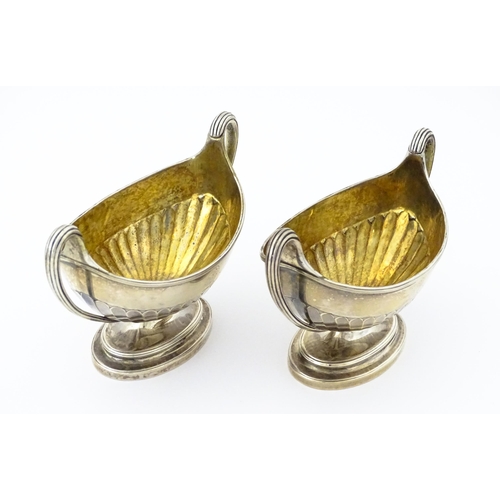 361 - A pair of George III silver twin handled salts with gilded interiors, hallmarked London 1784, maker ... 