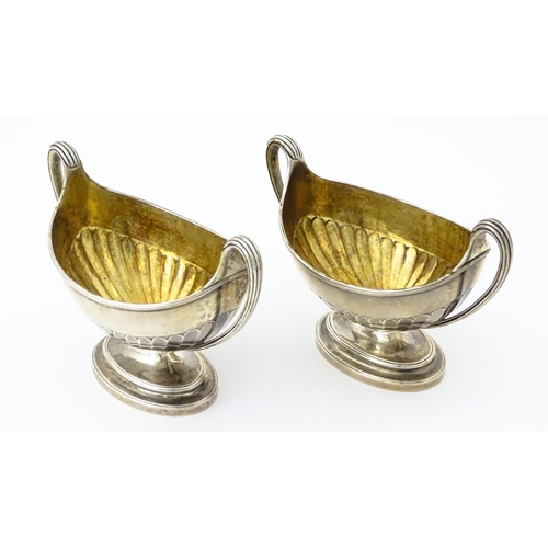 361 - A pair of George III silver twin handled salts with gilded interiors, hallmarked London 1784, maker ... 