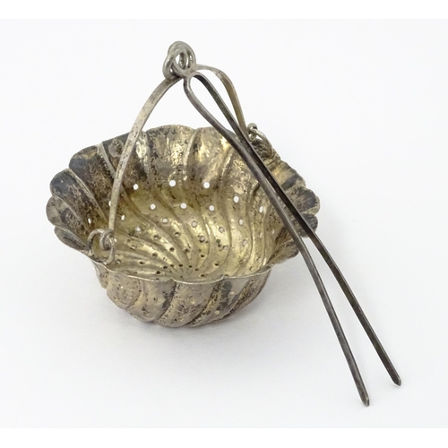 372 - A Chinese Export silver strainer of basket form with engraved decoration and spout hanger