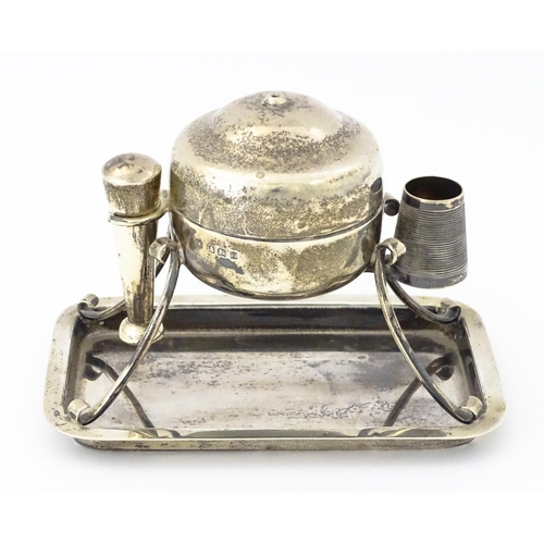 378 - A silver smoker's companion comprising central lidded container flanked by vesta keep and tamper, ra... 