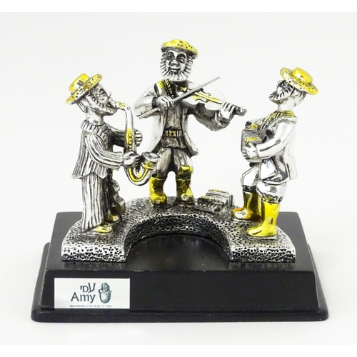 385 - A .925 Israeli silver model of a trio of Jewish musicians, by Amy. Bears plaque to base. In the mann... 