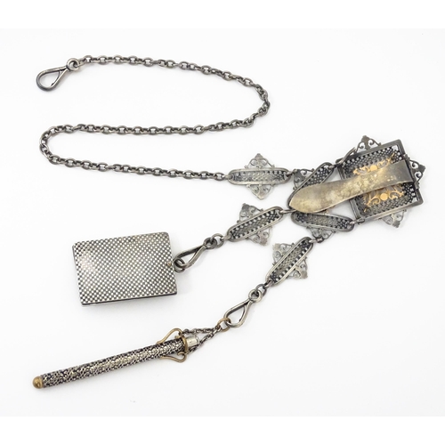 386 - A late 19th / early 20thC silver plate chatelaine with gilt metal highlights, having three hanging c... 