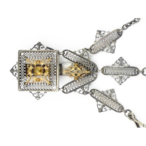 386 - A late 19th / early 20thC silver plate chatelaine with gilt metal highlights, having three hanging c... 