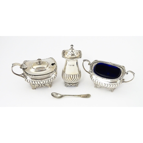 387 - A matched silver three piece cruet comprising salt, pepper and mustard, hallmarked London 1913 / 191... 