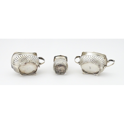 387 - A matched silver three piece cruet comprising salt, pepper and mustard, hallmarked London 1913 / 191... 