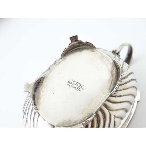 387 - A matched silver three piece cruet comprising salt, pepper and mustard, hallmarked London 1913 / 191... 