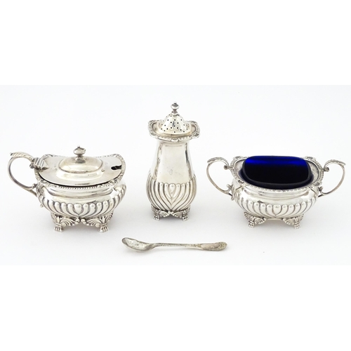 387 - A matched silver three piece cruet comprising salt, pepper and mustard, hallmarked London 1913 / 191... 