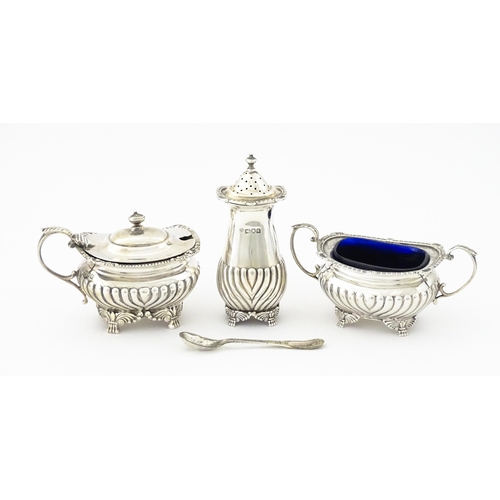 387 - A matched silver three piece cruet comprising salt, pepper and mustard, hallmarked London 1913 / 191... 