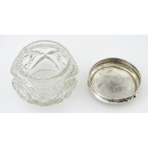 396 - A cut glass dressing table pot with silver lid hallmarked Birmingham 1923, maker Samuel M Levi. Appr... 