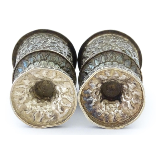 397 - A pair of white metal cruets / peppers of pedestal with floral and foliate decoration. Possibly Indi... 