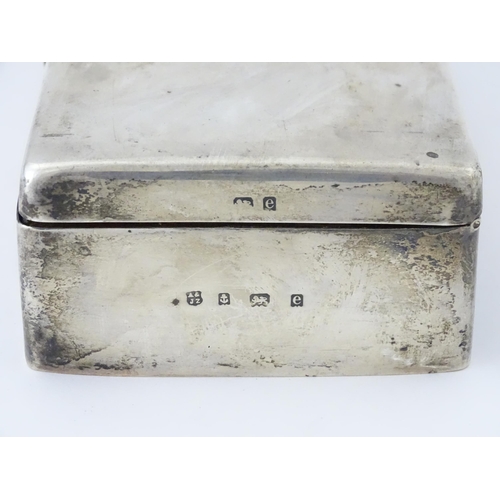 444 - A silver cigarette box with hinged lid and three sectional interior, hallmarked Birmingham 1904, mak... 