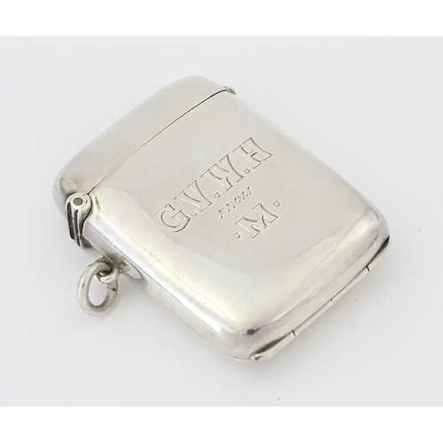 446 - A silver vesta case having a sprung hinged front to reveal locket section within. hallmarked Birming... 