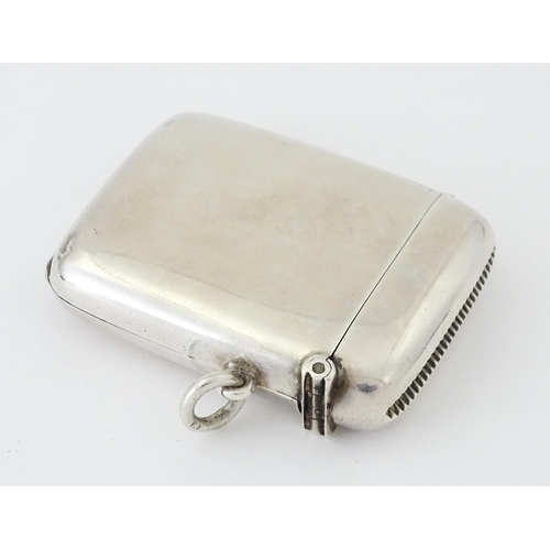 446 - A silver vesta case having a sprung hinged front to reveal locket section within. hallmarked Birming... 