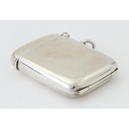 446 - A silver vesta case having a sprung hinged front to reveal locket section within. hallmarked Birming... 